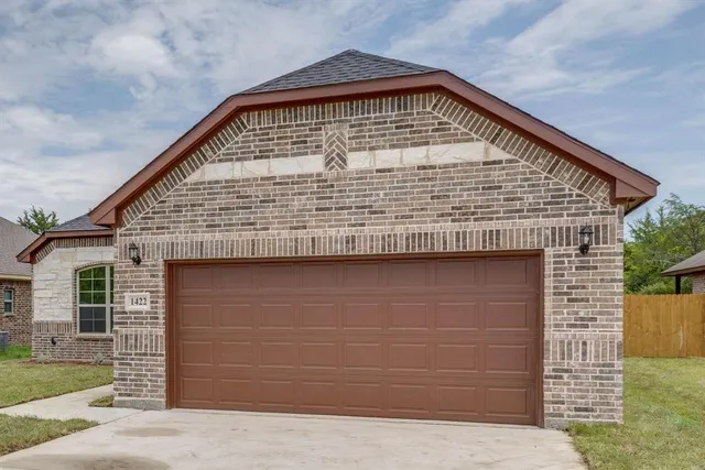 a front view of a house with garage