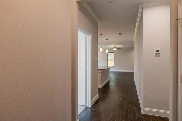 a view of a hallway with wooden floor