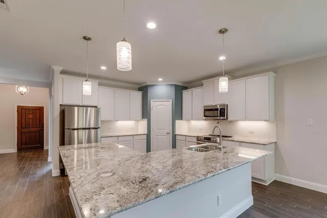 a large bathroom with a large mirror vanity and a sink