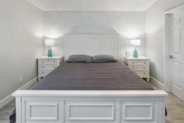 a bedroom with a bed and white cabinets