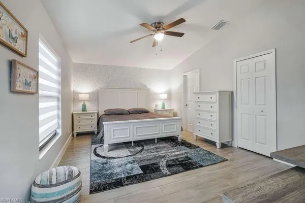 a bedroom with furniture and a window