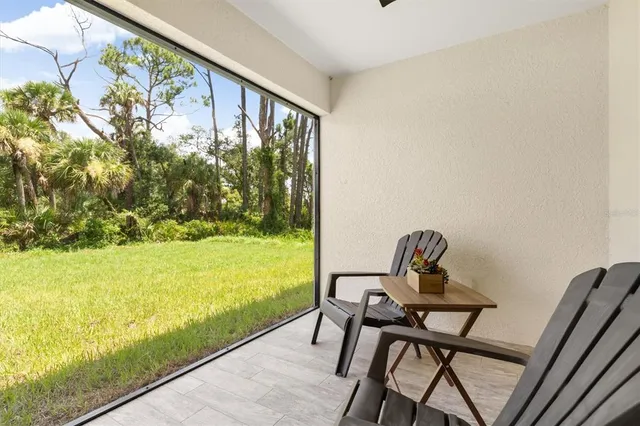 a view of a hallway with furniture and a potted plant