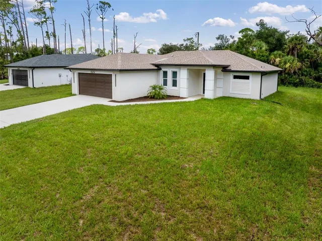 a front view of a house with a garden and yard