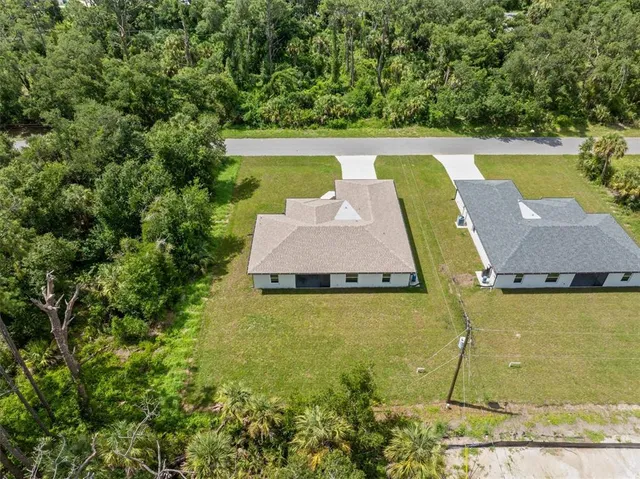 an aerial view of residential house with outdoor space