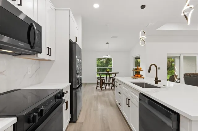 a kitchen with counter top space cabinets and appliances