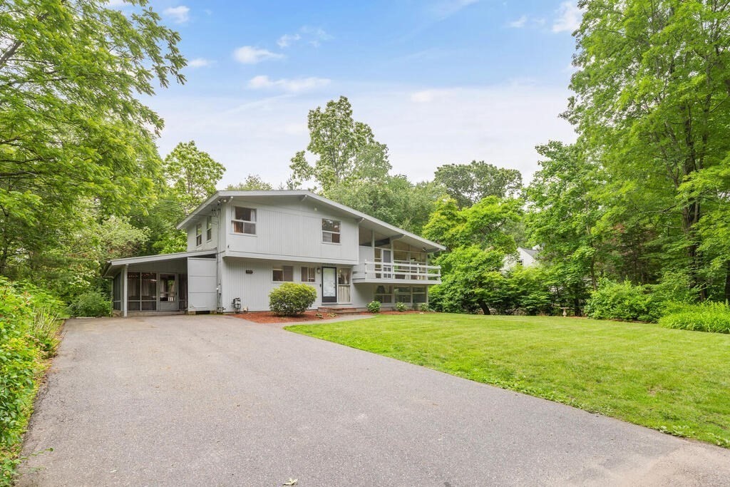 459 Winch Street Framingham, MA 01701 - Photo 2 of 34 a front view of house with yard and green space