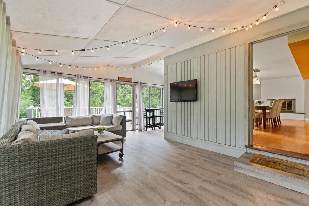 459 Winch Street Framingham, MA 01701 - Photo 21 of 34 a living room with furniture floor to ceiling window and wooden floor