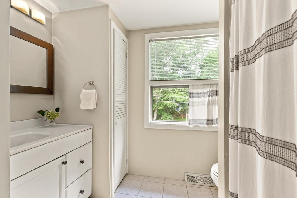 459 Winch Street Framingham, MA 01701 - Photo 25 of 34 a room with a window a sink and a mirror