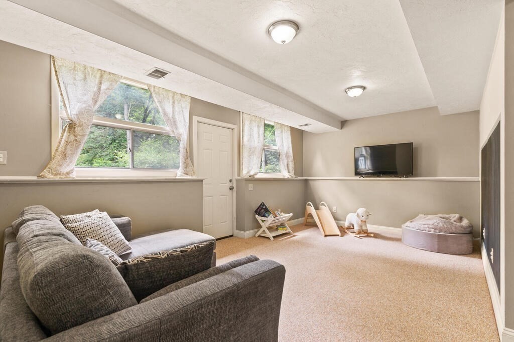 459 Winch Street Framingham, MA 01701 - Photo 10 of 34 a living room with furniture a flat screen tv and a window