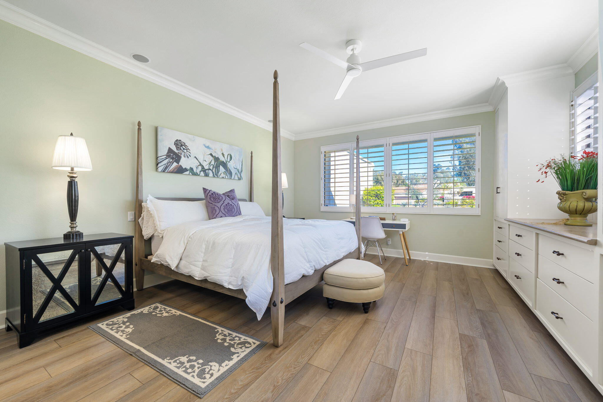 818 Inverness Drive Rancho Mirage, CA 92270 - Photo 26 of 43 a spacious bedroom with a bed and a dresser next to a window