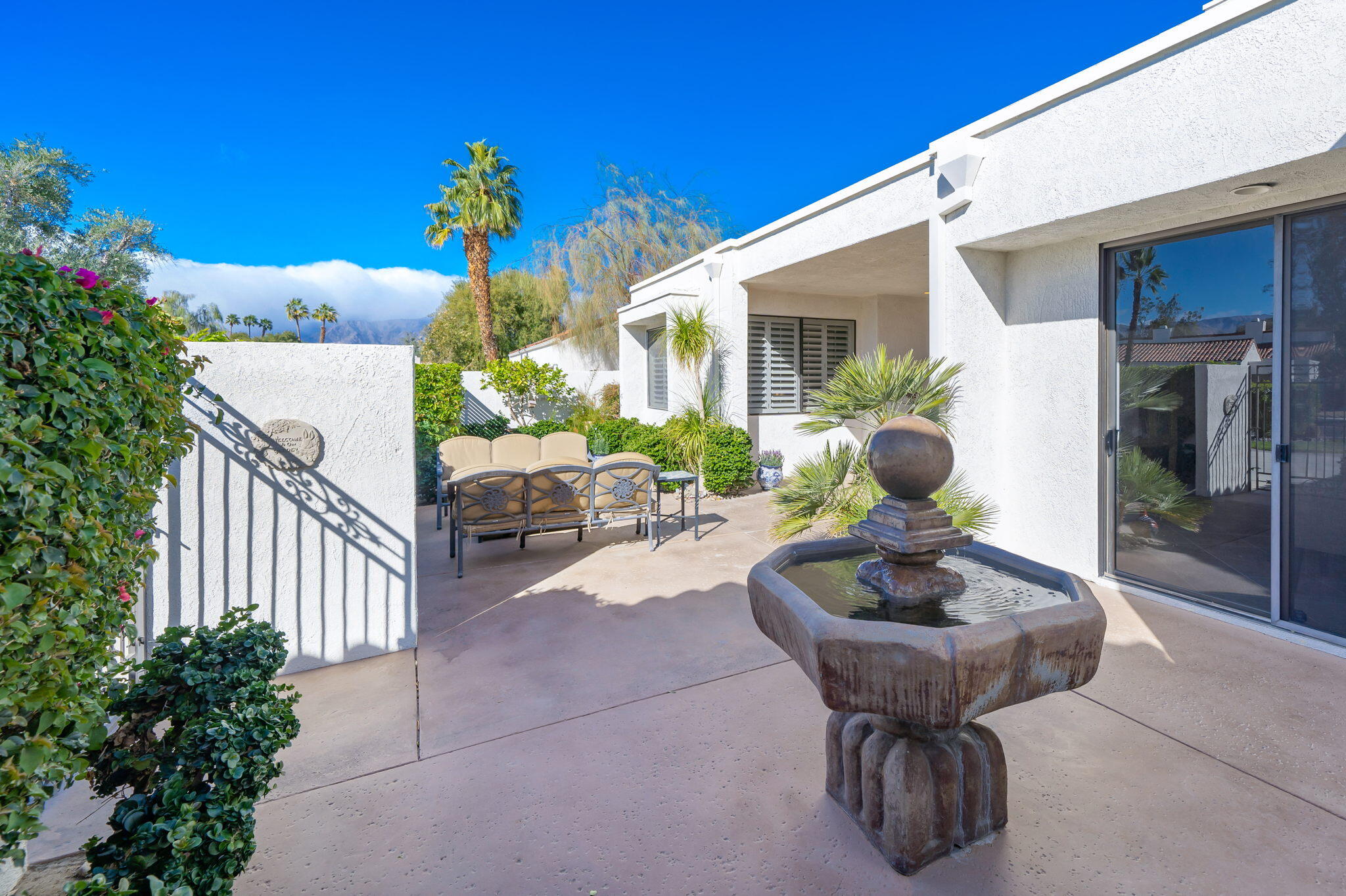 818 Inverness Drive Rancho Mirage, CA 92270 - Photo 8 of 43 a view of a patio with table and chairs and potted plants