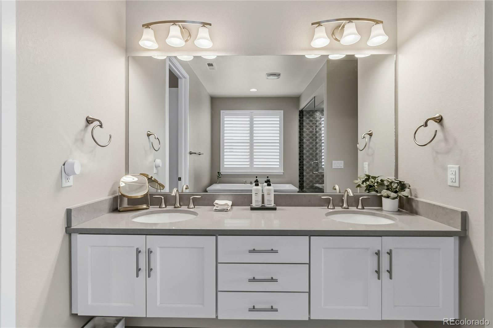 489 Meadowleaf Lane Highlands Ranch, CO 80126 - Photo 26 of 50 a bathroom with a double vanity sink and a mirror