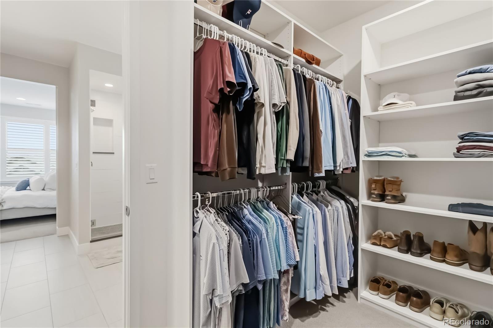 489 Meadowleaf Lane Highlands Ranch, CO 80126 - Photo 27 of 50 a view of walk in closet with clothes and shoes