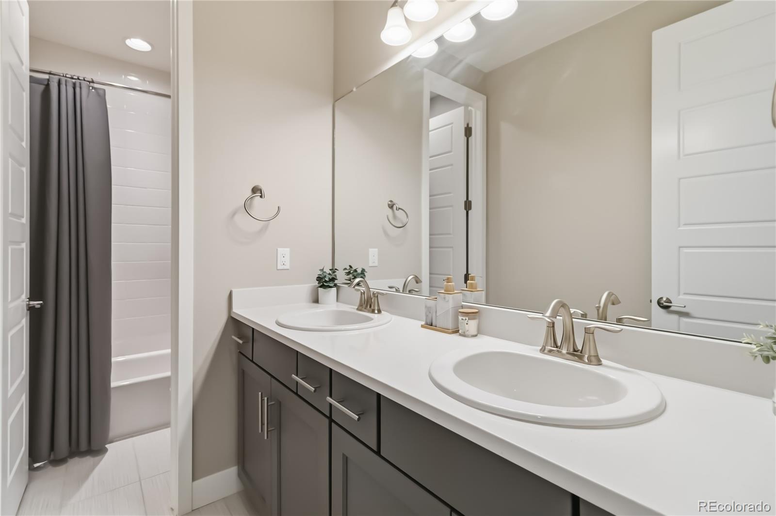 489 Meadowleaf Lane Highlands Ranch, CO 80126 - Photo 30 of 50 a bathroom with a double vanity sink mirror and double