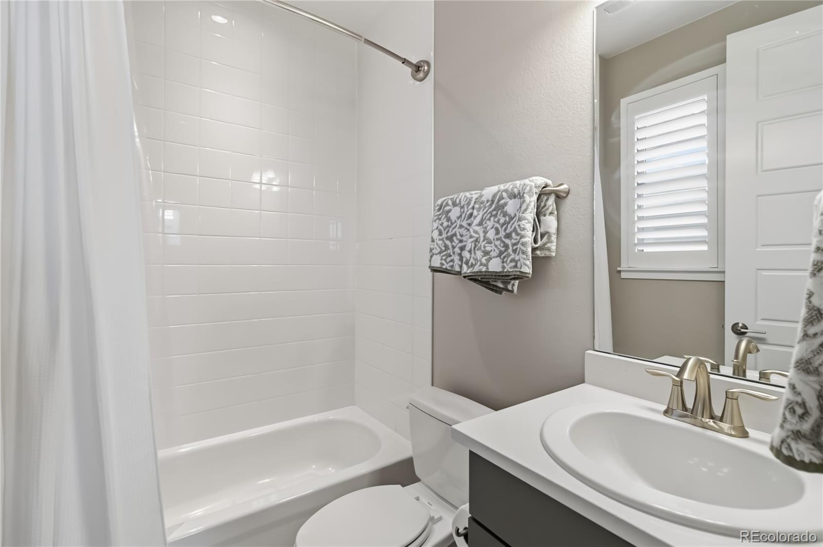 489 Meadowleaf Lane Highlands Ranch, CO 80126 - Photo 34 of 50 a bathroom with a sink toilet and shower