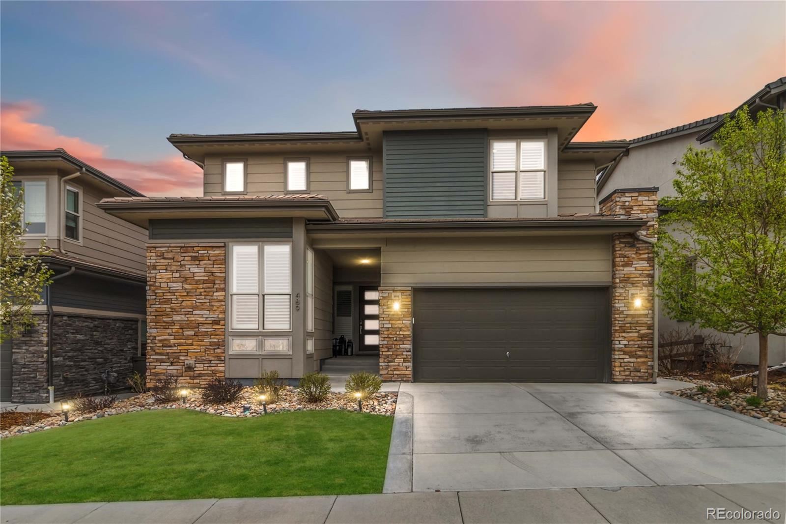 489 Meadowleaf Lane Highlands Ranch, CO 80126 - Photo 4 of 50 a front view of a house with garden