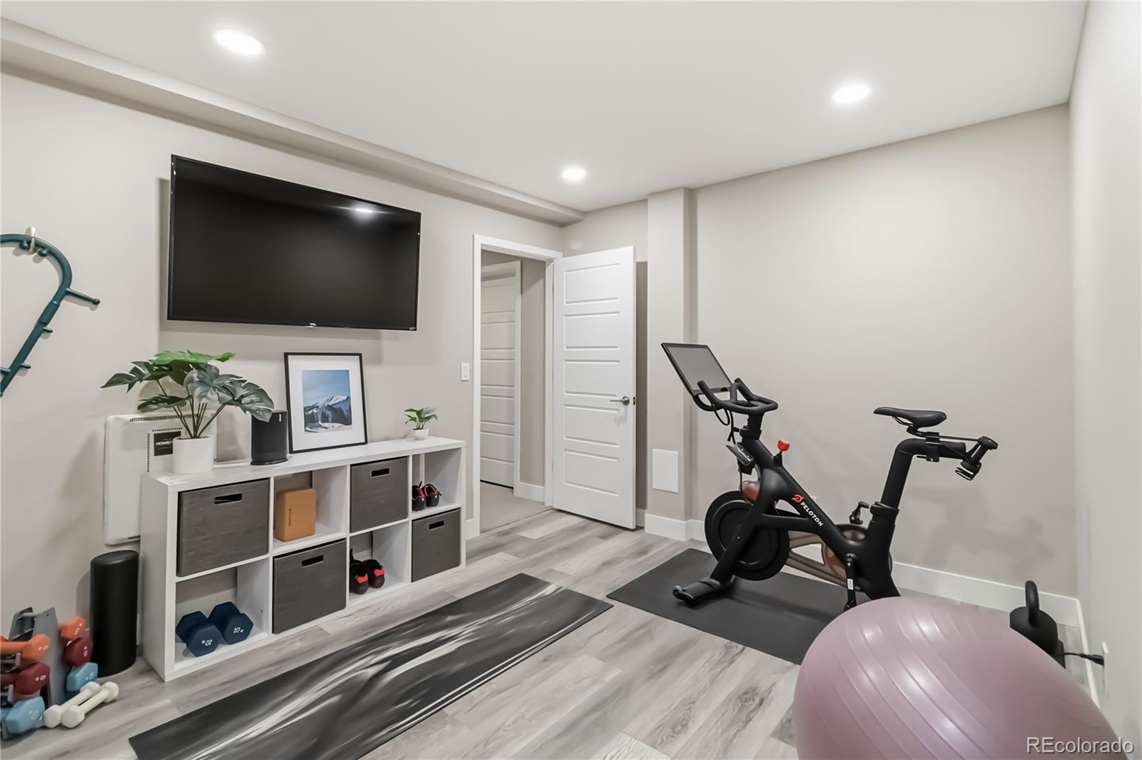 489 Meadowleaf Lane Highlands Ranch, CO 80126 - Photo 42 of 50 a view of a room with gym equipment and a flat screen tv