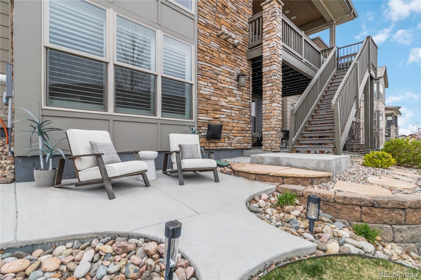 489 Meadowleaf Lane Highlands Ranch, CO 80126 - Photo 48 of 50 a view of a patio with couches table and chairs with wooden floor