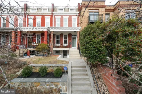 a front view of a multi story building with yard