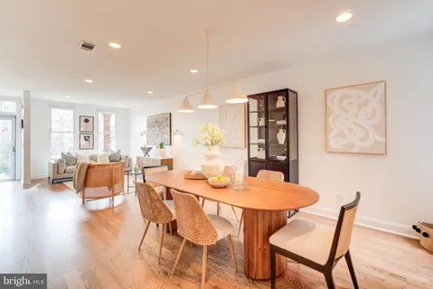 a dining room with furniture and wooden floor