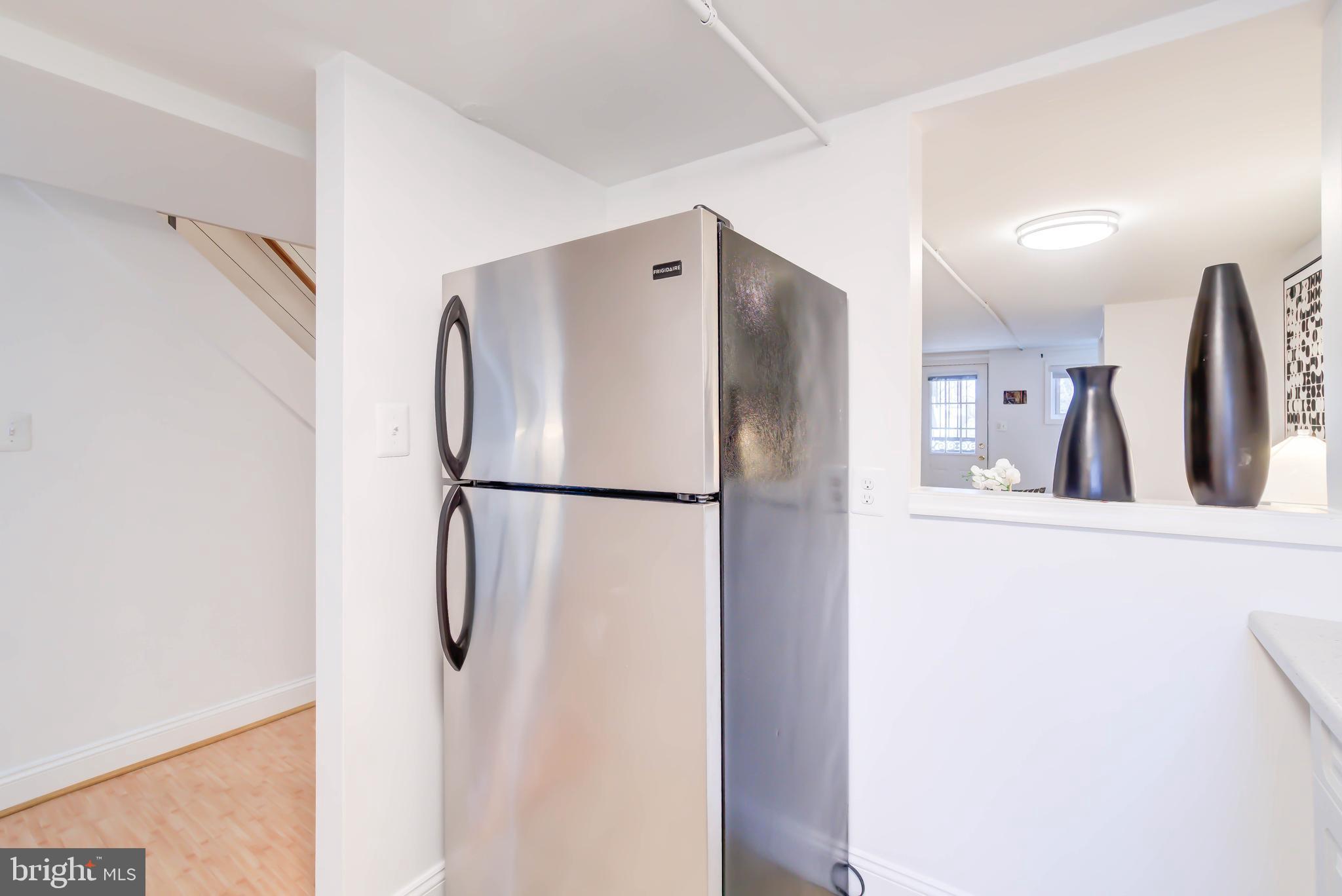 1111 Fairmont Street Northwest Washington, DC 20009 - Photo 45 of 55 Lower Level Kitchen w Pass Through to Dining Area