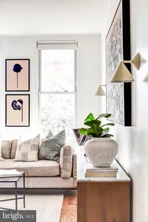 a living room with furniture and a potted plant
