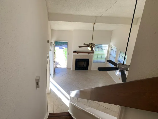 a view of a living room with furniture and a fireplace