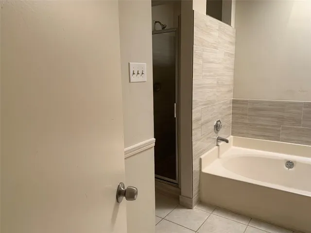 a bathroom with a bathtub and shower
