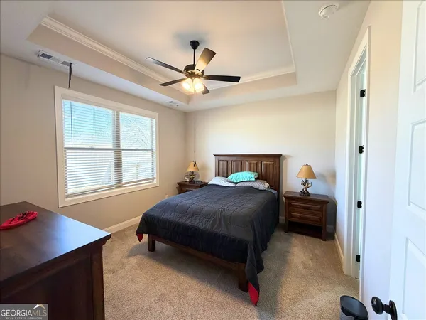 a bedroom with a bed and a chandelier