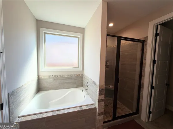 a bathroom with a bathtub and a shower