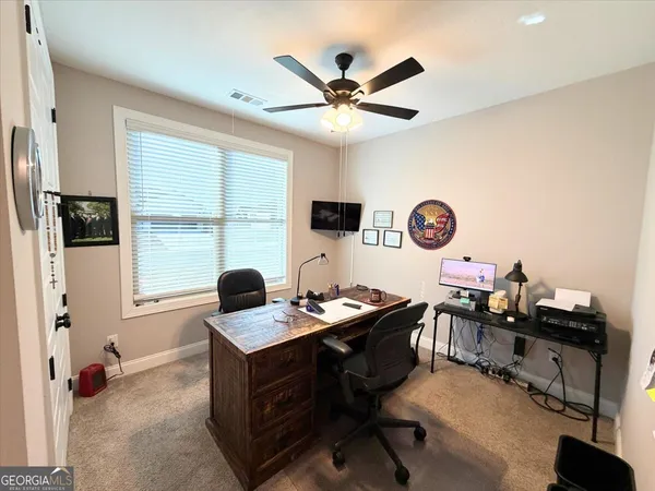 a work room with furniture and a window
