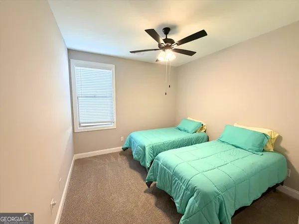 a bedroom with two beds and a window