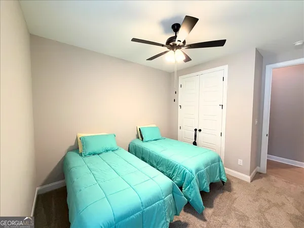 a bedroom with two beds and a chandelier