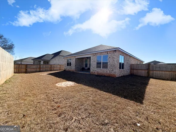 a front view of house with yard and car parked