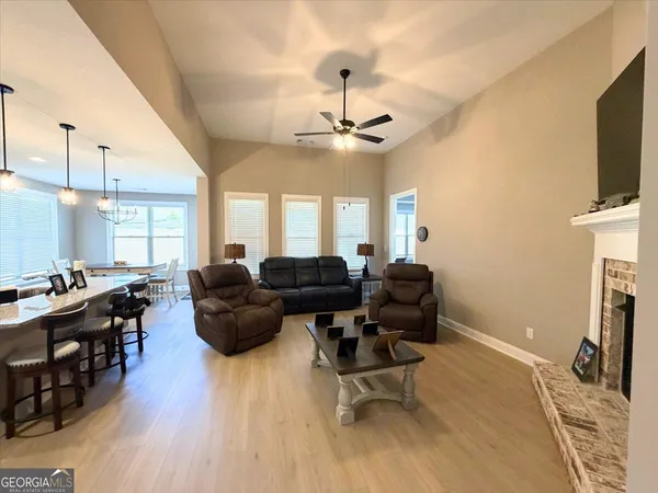a living room with furniture a fireplace and a flat screen tv