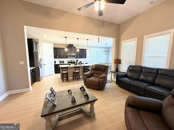 a living room with furniture kitchen and a table