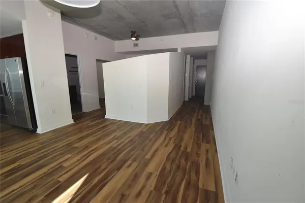 a view of a hallway with wooden floor