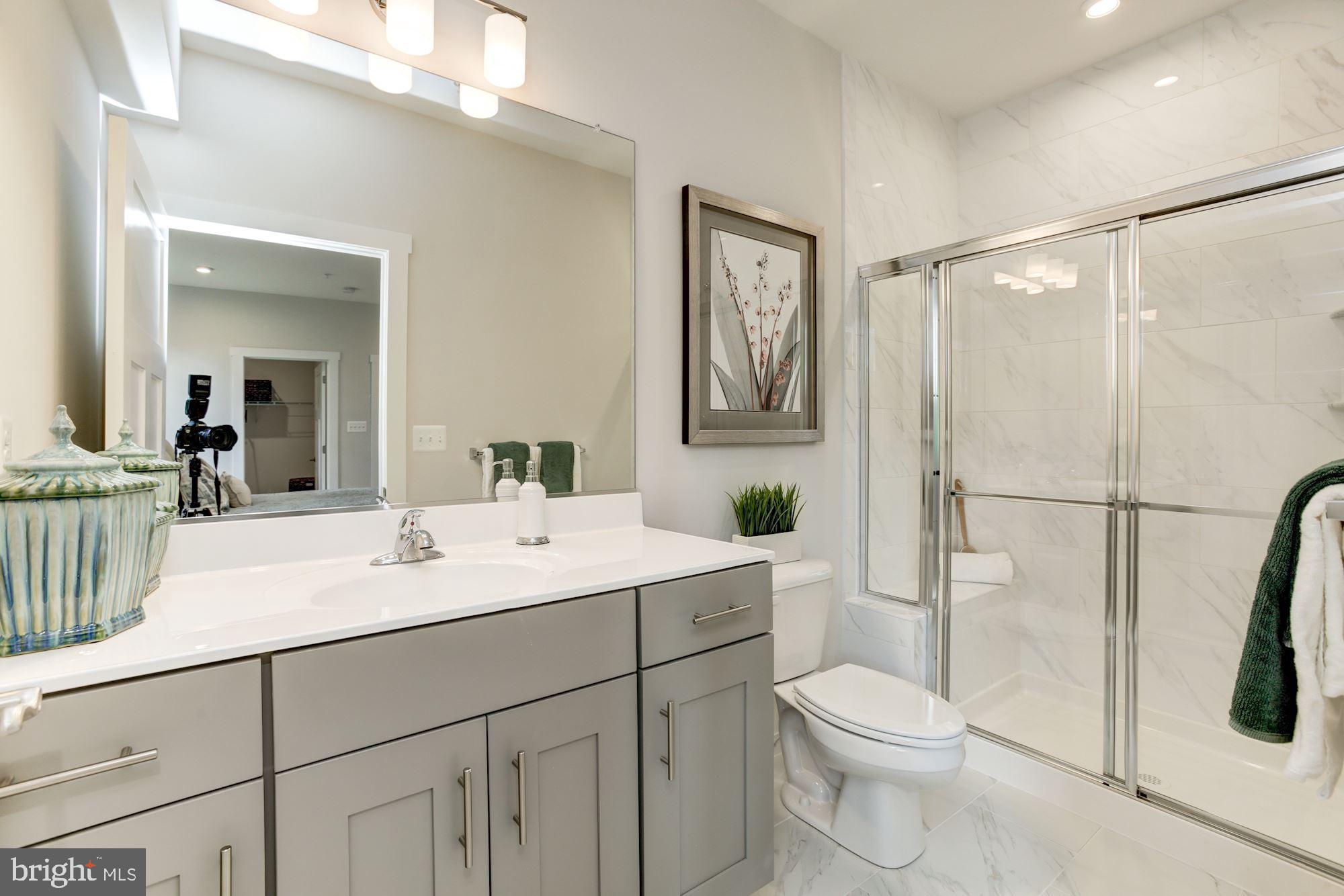 1713 Copperleaf Boulevard Hanover, MD 21076 - Photo 22 of 48 a bathroom with a sink a toilet a mirror and shower