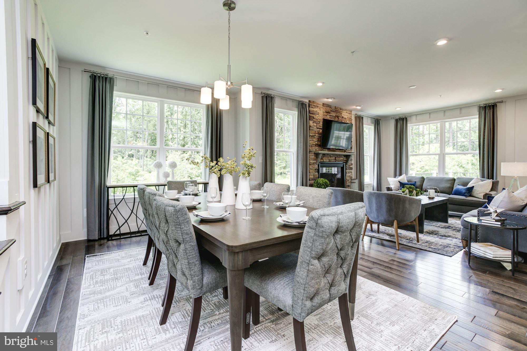 1713 Copperleaf Boulevard Hanover, MD 21076 - Photo 6 of 48 a view of a dining room and livingroom with furniture wooden floor a chandelier