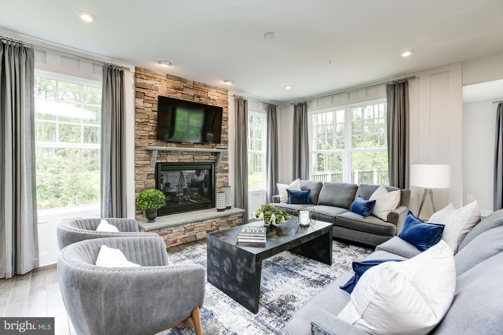 1713 Copperleaf Boulevard Hanover, MD 21076 - Photo 9 of 48 a living room with furniture and a fireplace