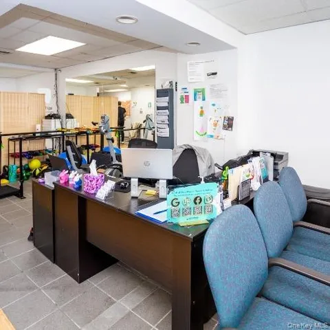 a room with gym equipment and potted plants