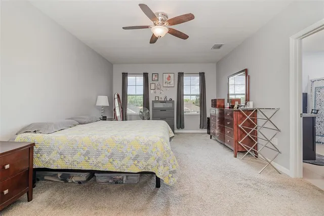 a bedroom with a bed and a large window