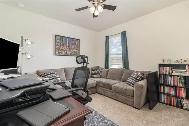 a work room with furniture and a bookshelf
