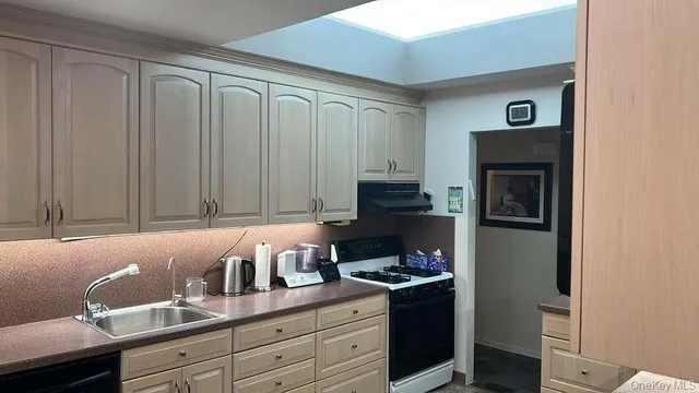 a kitchen with a cabinets and a stove top oven