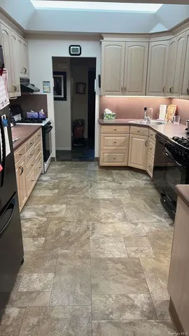 a kitchen with a stove a sink and a refrigerator