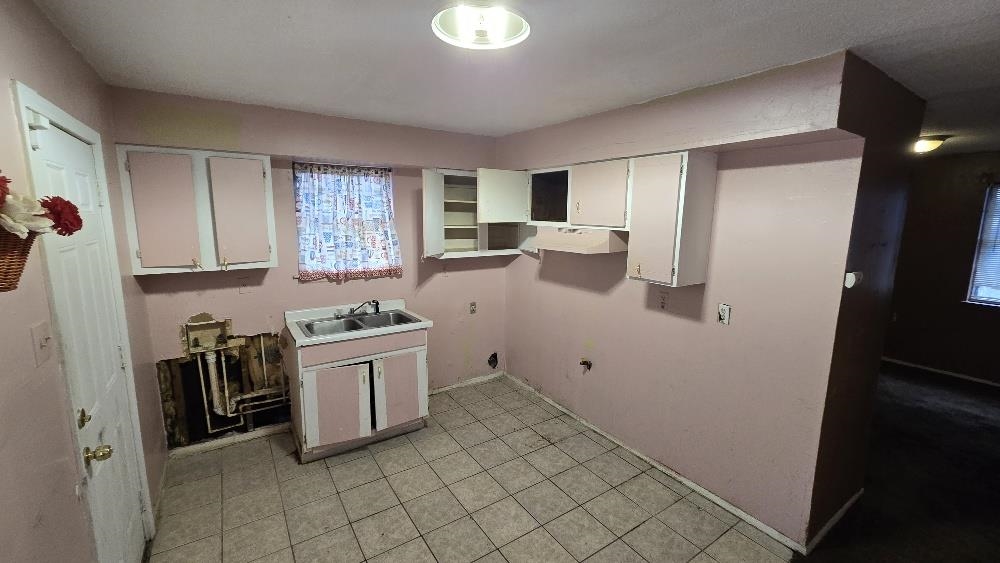 753 King Road Memphis, TN 38109 - Photo 12 of 17 a kitchen with a stove a sink and a refrigerator
