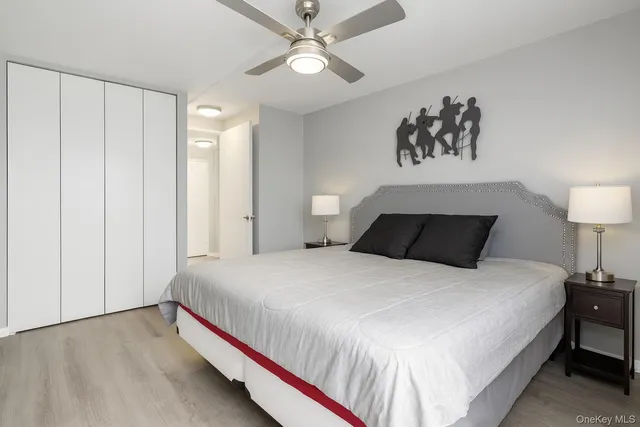 a bedroom with bed and a chandelier