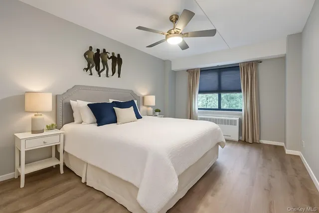 a bedroom with a large bed and a chandelier