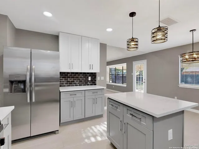 a kitchen with a refrigerator and countertop
