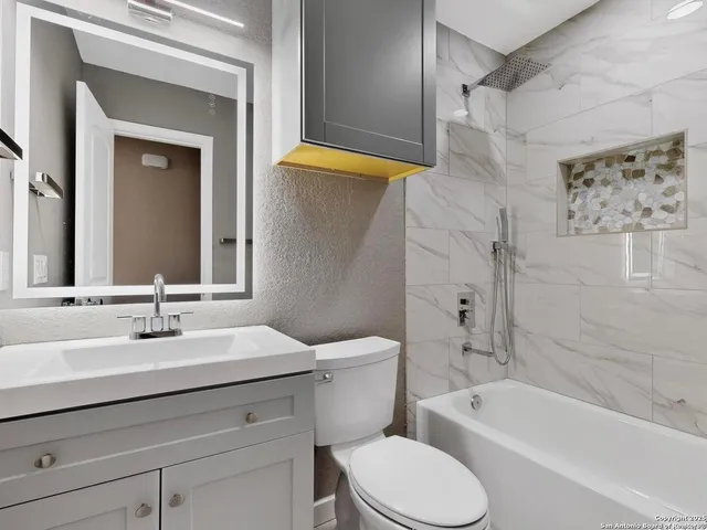 a bathroom with a sink a toilet and a bathtub